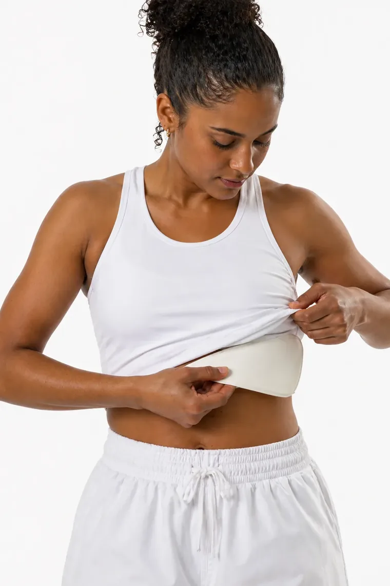 Athlete showing the chest protection insert inside her training top